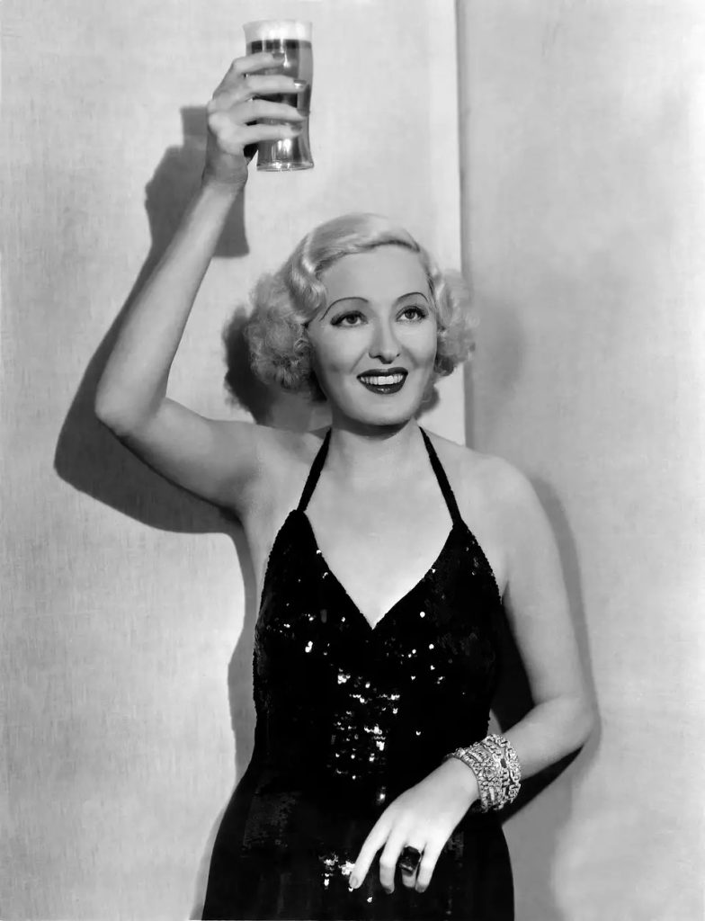 Former Ziegfeld showgirl and actress Peggy Hopkins Joyce raises a glass of beer to celebrate the end of prohibition, Hollywood